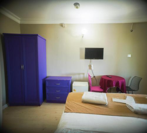 a bedroom with a blue cabinet and a bed at White Palace Büyükada in Adalar