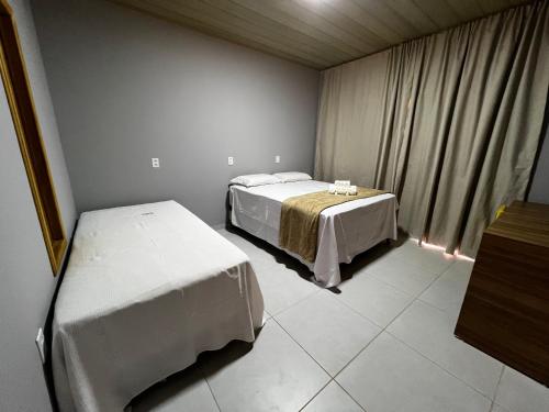 Ein Bett oder Betten in einem Zimmer der Unterkunft POUSADA AMORIM
