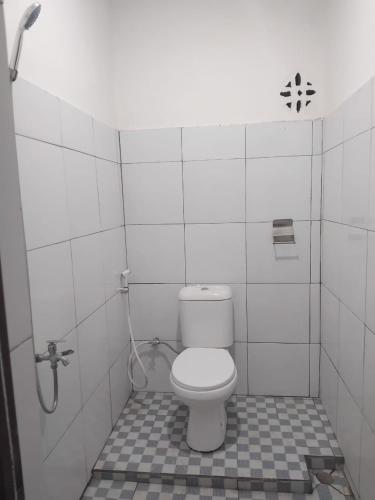 a bathroom with a toilet and a shower at Eltari Homestay in Tetebatu