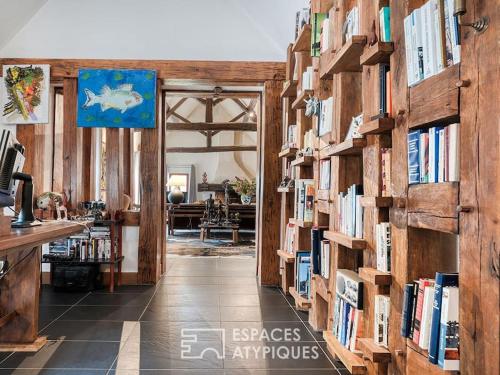 a hallway with bookshelves filled with books at Grande Maison familiale in Maillebois