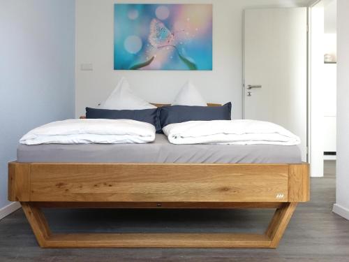 a bed in a bedroom with a wooden frame at ELYs-Home in Isny im Allgäu