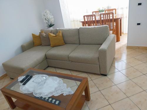 a living room with a couch and a table at Apartment Ross in Vlorë