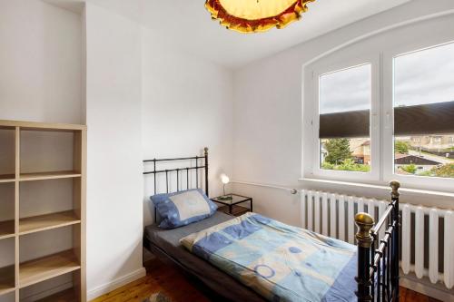 a small bedroom with a bed and a window at Ferienhaus Waldliebe in Hüttenrode