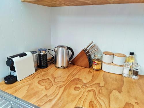 a kitchen counter top with a coffee maker and utensils at Delight in Birch-Lake View Holiday Home in Taupo