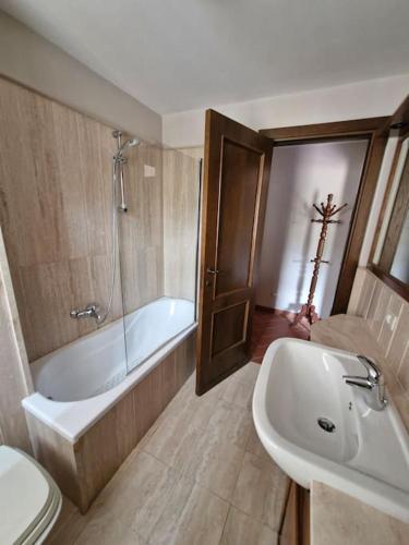 a bathroom with a tub and a toilet and a sink at Maya house in Cetona