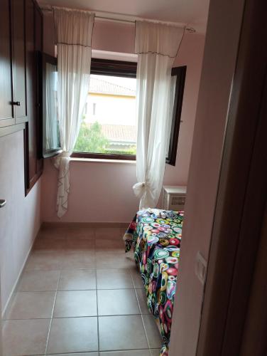 a small room with a bed and a window at VILLA MATI' in Pizzo