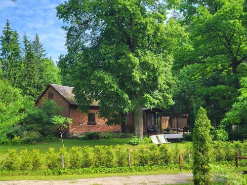 a brick house in the middle of a yard at LejasVāgneris in Tukums