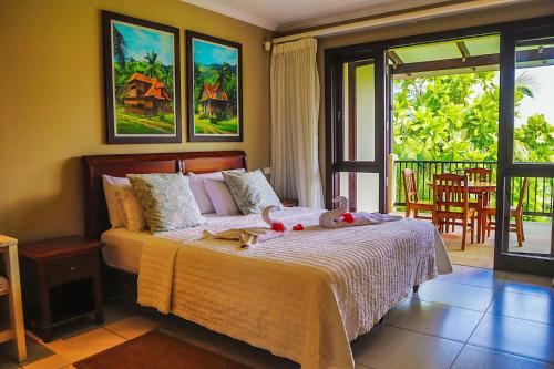 a bedroom with a bed and a balcony at Eden Island Luxury Holiday Home in Eden Island