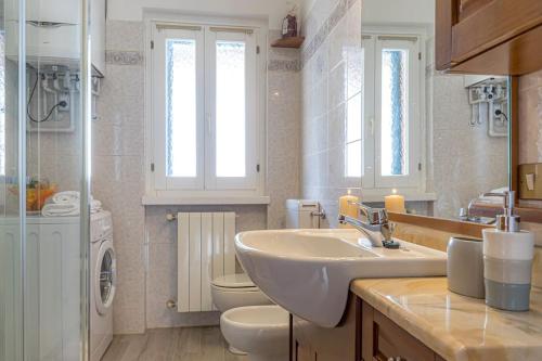 a bathroom with a sink and a toilet at Bonardi's Home - enjoy the lakes! in Carlazzo
