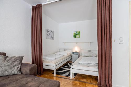 ein Wohnzimmer mit zwei Betten und einer Couch in der Unterkunft Harzburg Stube in Bad Harzburg