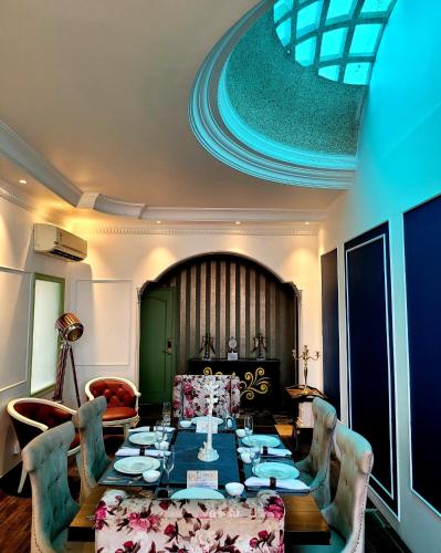 a dining room with a long table and chairs at Victorian Elegance Luxury Stays in Amritsar