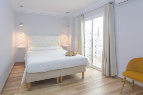 Katil atau katil-katil dalam bilik di Hostal La Ermita