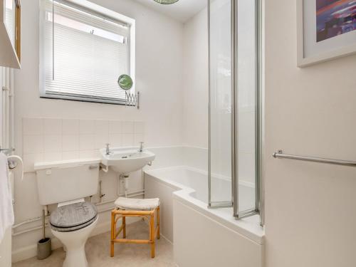 a bathroom with a toilet and a sink and a shower at Beach View Cottage in Felixstowe