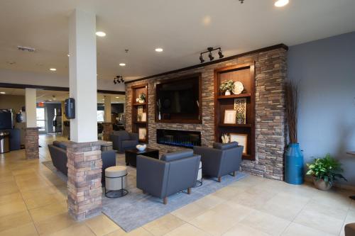 a lobby with couches and a brick fireplace at Microtel Inn & Suites by Wyndham Waynesburg in Waynesburg