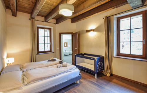 a bedroom with a bed and a piano in it at Awesome Home In Paluzza in Paluzza