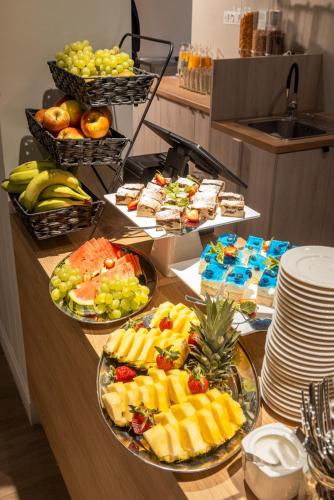a buffet with several plates of fruit on a counter at Belmar Park in Władysławowo