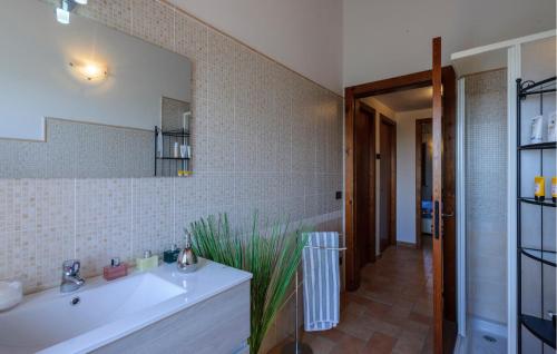a bathroom with a sink and a mirror at Cozy Home In Terre Roveresche With Wifi in Tavernelle