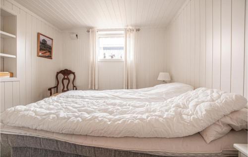a white bed in a white room with a window at 3 Bedroom Gorgeous Apartment In Rros in Røros