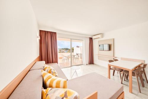 a living room with a couch and a table at Apartamentos Vista Club in Santa Ponsa