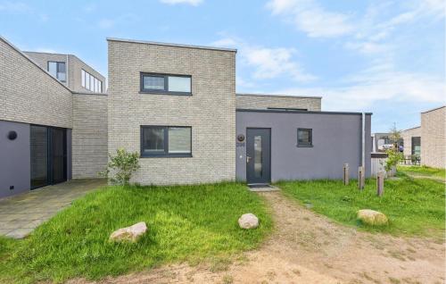 a brick house with rocks in the yard at Amazing Home In Lembruchdümmer See in Lembruch