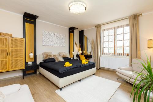 a bedroom with a king sized bed and a couch at KUMBHAKA Villa in Csopak