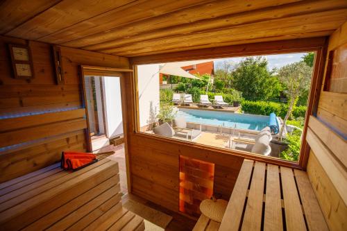 an inside view of a wooden cabin with a large window at KUMBHAKA Villa in Csopak