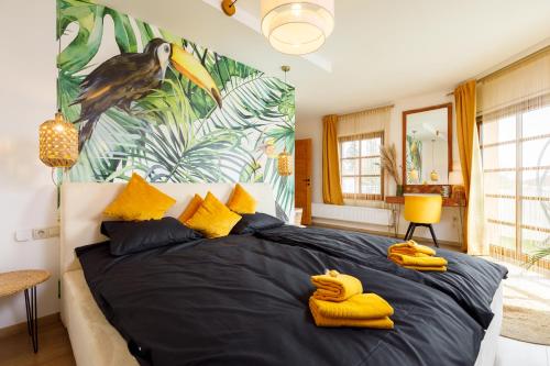 a bedroom with a large bed with bananas on it at KUMBHAKA Villa in Csopak