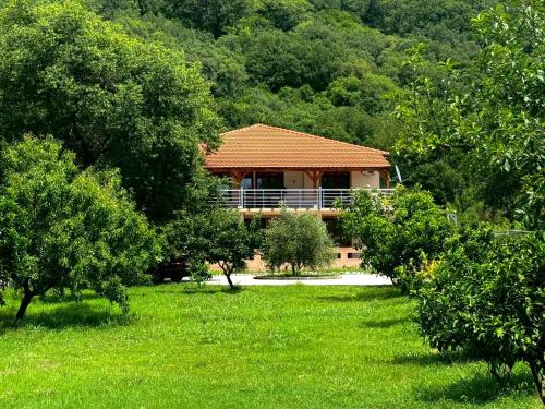 a house in the middle of a field with trees at STARS RESIDENCE in Petrovac na Moru
