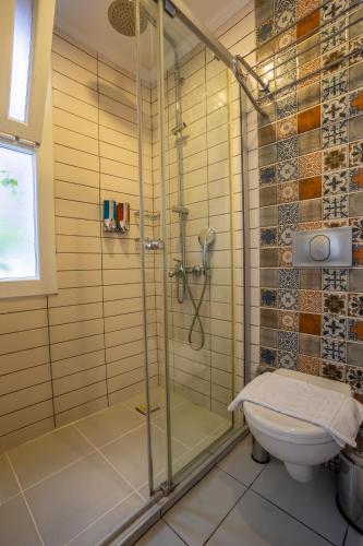 a bathroom with a shower and a toilet at Hideaway in Kas