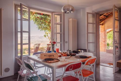 a dining room with a table with a bowl of fruit on it at Scarpa Villas - Barolo Luxury Escape in Verduno