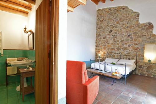 a bedroom with a bed and a table and a chair at Terre Di Himera in Buonfornello