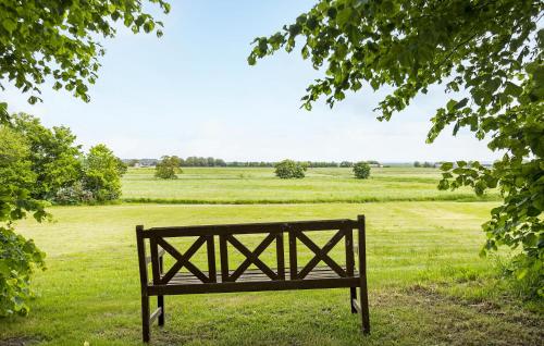 a bench sitting in the middle of a field at Lejl 3 in Brovst