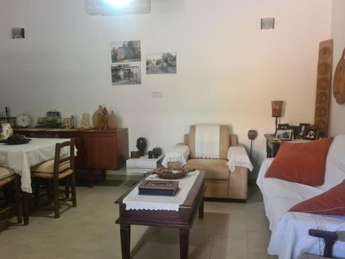 a living room with a couch and a table at Ivi's House Giolou in Paphos City