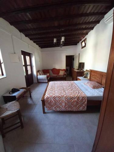 a bedroom with two beds and a living room at Ivi's House Giolou in Paphos City