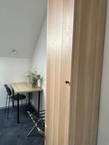 a door to a room with a desk and a table at Moment in Strzelce Opolskie