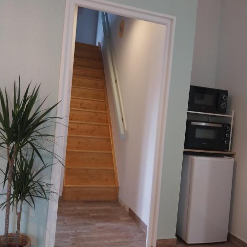 a stairway leading up to a room with wooden stairs at Gite dans une ancienne corps de ferme C in Provins