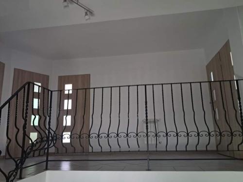 a staircase with a metal railing in a room at Pluski Dom PROJEKT PLUSKI nad Jeziorem Pluszne in Pluski