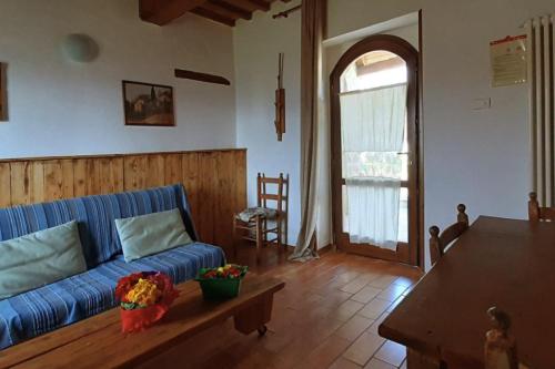 a living room with a blue couch and a table at Country House Ca' Vernaccia in Urbino