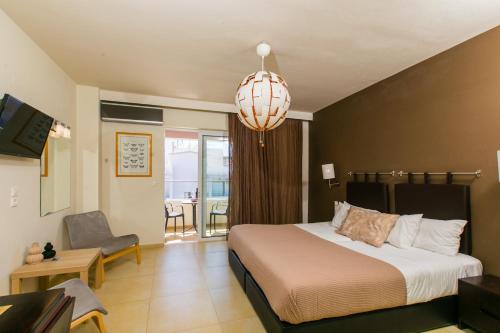 a bedroom with a bed and a living room at Cosmos Hotel in Rethymno Town
