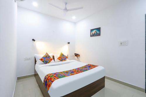 a white room with a large bed in it at FabHotel VK's in Hyderabad