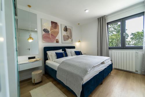 a bedroom with a large bed and a window at Villa Mare&Monti in Opatija, Heated pool with sea view in Opatija