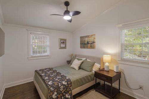 een slaapkamer met een bed en een nachtkastje met een lamp bij 2BR 2Bath Chamblee Brookhaven Ashford Park Brand new furnishings throughout in Atlanta