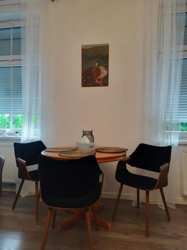 a dining room with a table and chairs at Apartament GALERIA in Nysa