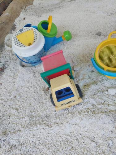 a toy truck and other toys in the sand at Biobauernhof Habersatter in Radstadt