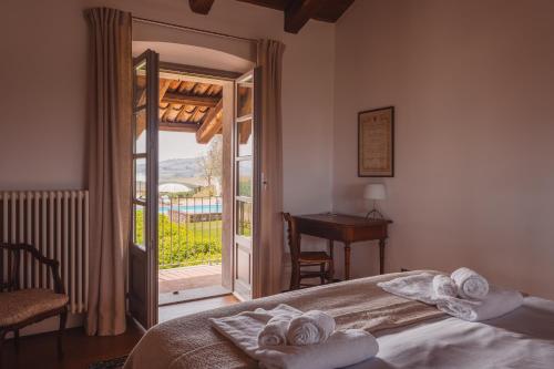a bedroom with a bed and a door to a balcony at Scarpa Villas - Barolo Luxury Escape in Verduno