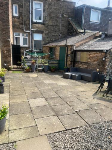 a patio in front of a brick building at Teviot View Holiday Let’s Hawick in Hawick