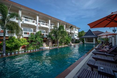 a swimming pool in front of a hotel at Neptune's Villa in Haad Rin