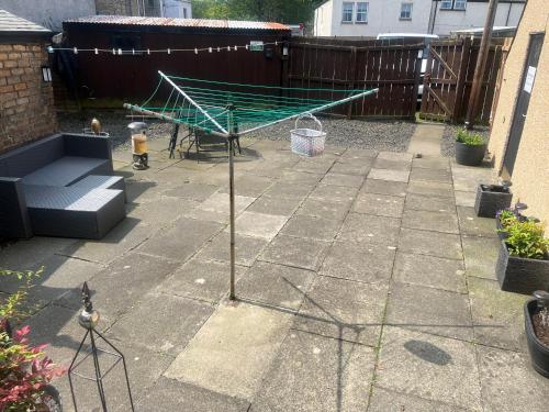 a patio with a green table and a bench at Teviot View Holiday Let’s Hawick in Hawick