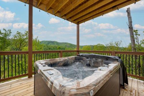 a hot tub on the deck of a house at Peace Giver by Eden Crest in Gatlinburg