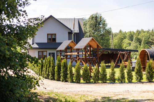 a house with a garden in front of it at SZUMI LAS in Białowieża